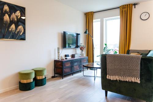 a living room with a couch and a table at New Åkrahamn coast house in Sæveland
