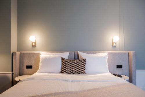 a bedroom with a bed with two pillows on it at Mercure Hotel Pforzheim in Pforzheim
