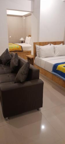 a living room with a couch and two beds at Ocean Resort Amed in Amed