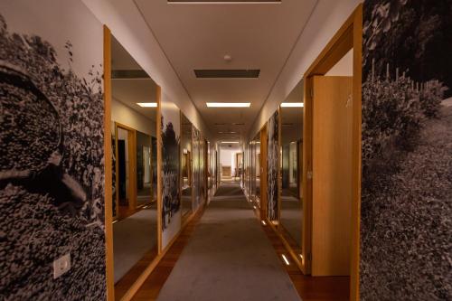 a hallway in a building with paintings on the walls at FH Hotel Rural in Felgueiras