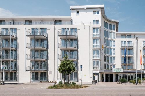 a large white building with a tree in front of it at Mercure Hotel Pforzheim in Pforzheim