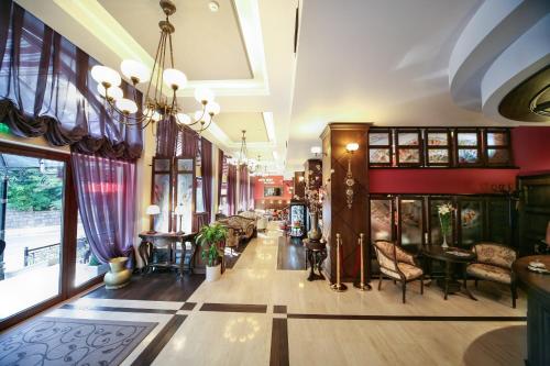 a lobby of a building with chairs and tables at Retro Hotel in Haskovo
