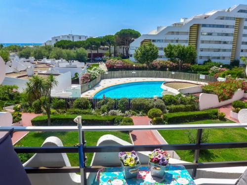 a view of the pool from the balcony of a hotel at Apartment Du Soleil-2 by Interhome in La Grande Motte