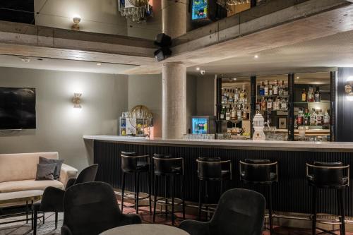a bar with chairs and a couch in a room at Mercure Hotel Pforzheim in Pforzheim