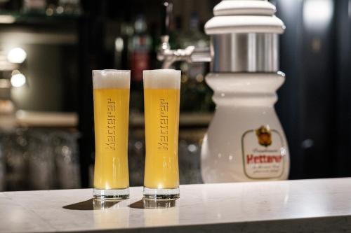 two glasses of beer sitting on top of a counter at Mercure Hotel Pforzheim in Pforzheim