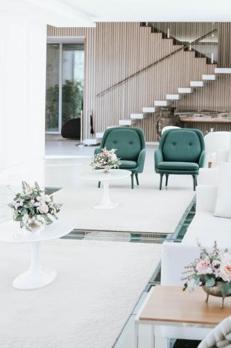 a lobby with green chairs and tables and stairs at FH Hotel Rural in Felgueiras