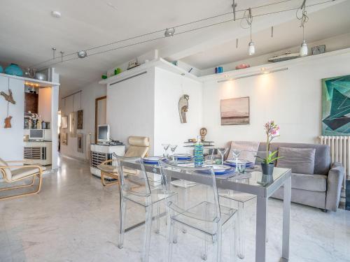 a dining room and living room with a table and chairs at Apartment Copacabana Promenade des Anglais by Interhome in Nice