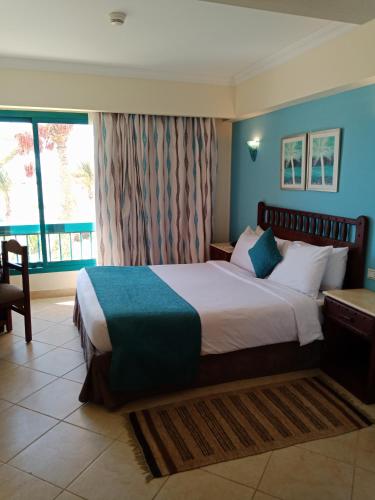 a bedroom with a large bed and a window at Green Sudr Resort in Ras Sedr