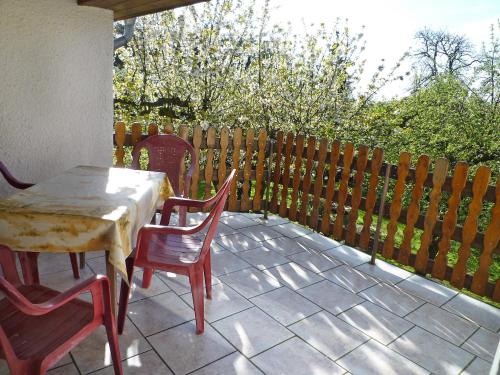 a table and chairs on a patio with a fence at Holiday Home Zerna by Interhome in Bad Muskau