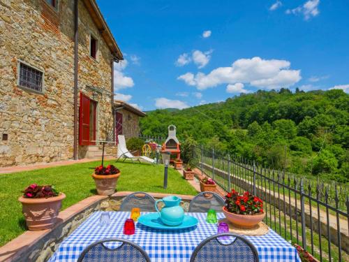 a table with a blue tea pot on top of a yard at Holiday Home Locazione Turistica Selvapiana by Interhome in Greve in Chianti