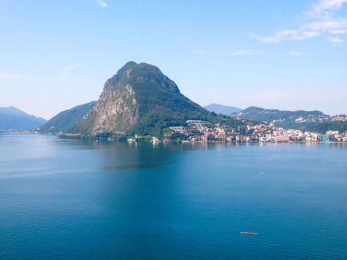 a mountain in the middle of a large body of water at Apartment Castagnola - Utoring-8 by Interhome in Lugano