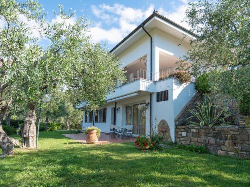 a large white house with a yard and trees at Apartment Alberto B by Interhome in Diano Castello