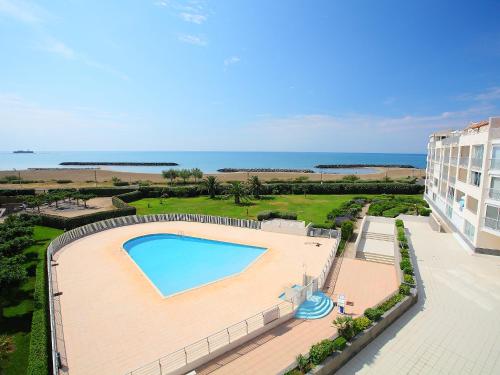 an overhead view of a swimming pool and the ocean at Apartment Les Rivages de Rochelongue-3 by Interhome in Cap d'Agde