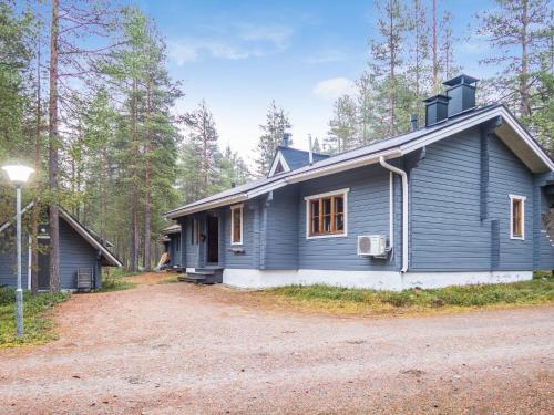 ein blaues Haus mitten im Wald in der Unterkunft Holiday Home Purnukylä 6 by Interhome in Ruka