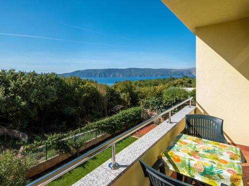 a balcony with a bench and a view of the water at Studio Jasna-4 by Interhome in Pinezici