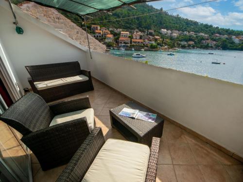 a balcony with chairs and a view of the water at Holiday Home Repak by Interhome in Brna