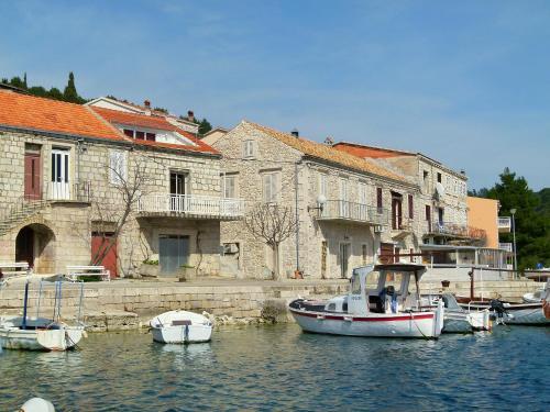 a group of boats in the water next to buildings at Holiday Home Repak by Interhome in Brna