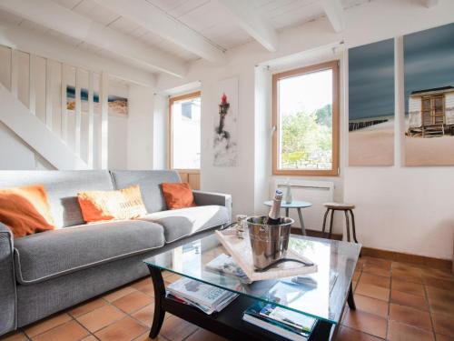 a living room with a couch and a table at Holiday Home la Voile by Interhome in La Trinité-sur-Mer