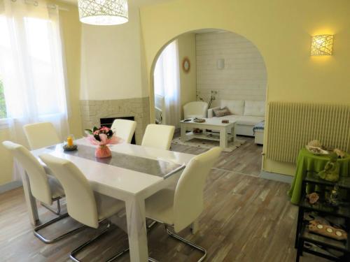 a dining room with a white table and chairs at Holiday Home Les Hirondelles - ADS185 by Interhome in Andernos-les-Bains