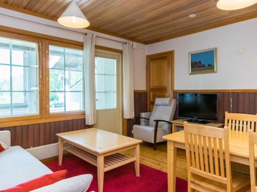a living room with a couch and a tv at Holiday Home Vadelma by Interhome in Kukkola