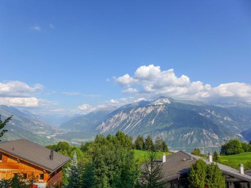 a view of a mountain range from a house at Chalet Chalet Aglaia by Interhome in Crans-Montana