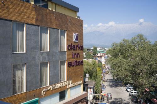 a building with a sign on the side of it at Clarks Inn Suites Kangra in Kangra