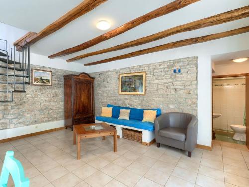 a living room with a couch and a chair at Holiday Home Danijela by Interhome in Žminj