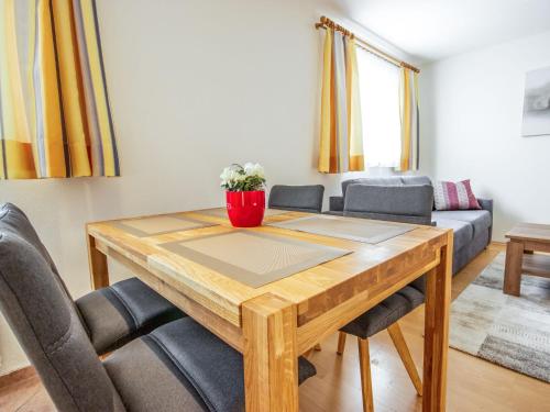 a dining room table with chairs and a couch at Apartment Christine by Interhome in Prutz