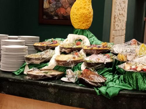 a table with many plates of food on it at Green Sudr Resort in Ras Sedr