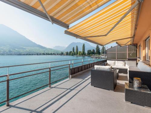 a balcony with a view of the water at Holiday Home Seestern direkt am See by Interhome in Ennetbürgen