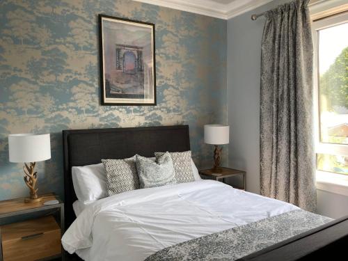a bedroom with a bed with blue wallpaper at Rosebank in Spean Bridge