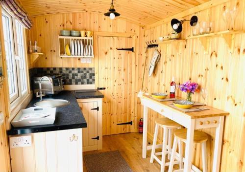 a kitchen with a sink and a counter in a cabin at Remarkable Shepherds Hut in a Beautiful Location in Perth