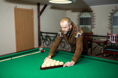a man playing a game of pool on a pool table at Aquadar in Manʼkivka