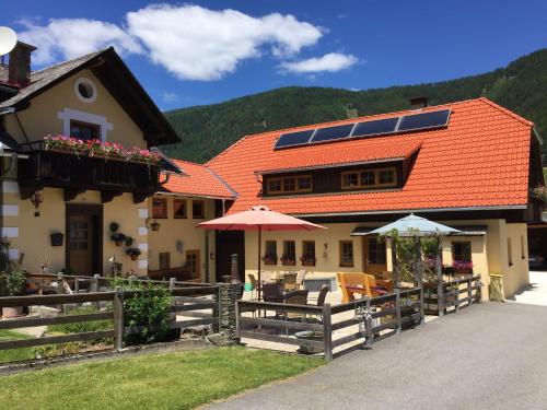 a house with solar panels on the roof at Apartment Ferienwohnung Gurkhof 1 - Nockhaus by Interhome in Gnesau