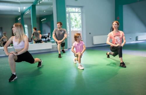 a group of people sitting in a room with a little girl at Aquadar in Manʼkivka