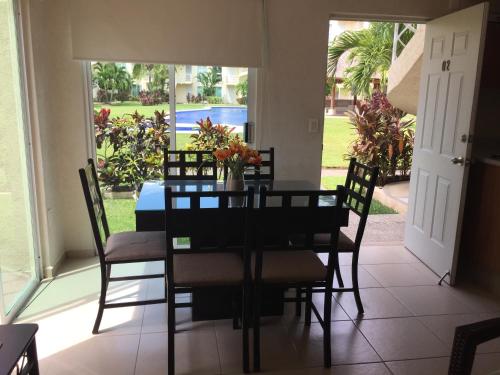 a dining room with a table and chairs at Acapulco, Departamento PB en Marina Diamante in Acapulco