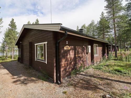 a small brown building in the middle of a forest at Holiday Home Jormakka by Interhome in Sirkka