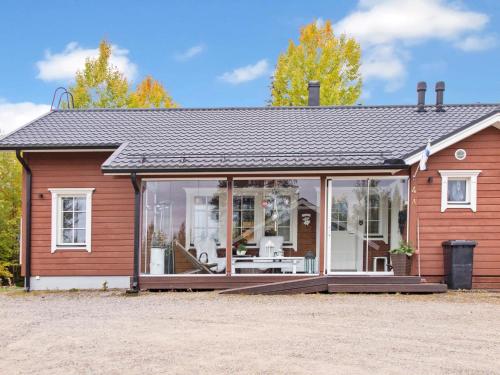 ein kleines rotes Haus mit großen Glasfenstern in der Unterkunft Holiday Home Casa abuela by Interhome in Tahkovuori