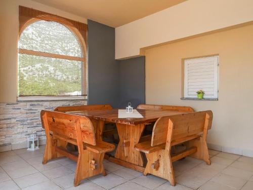 a dining room with a wooden table and chairs at Holiday Home Golic - KBG302 by Interhome in Karlobag
