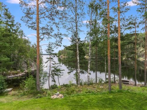 a view of a lake through the trees at Holiday Home Lahukka by Interhome in Hurissalo