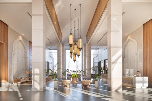 a lobby with white columns and chandeliers at Steigenberger Resort Ras Soma in Hurghada