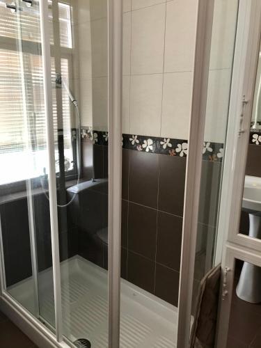 a shower with a glass door in a bathroom at Casa Los Molineros in Cortes de la Frontera
