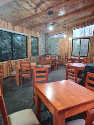 a dining room with wooden tables and chairs at Cerveceria y Hosteria Lican in Villarrica