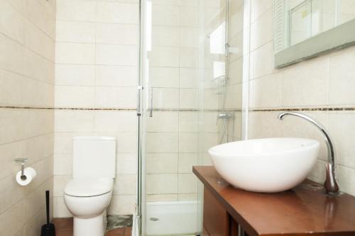 a bathroom with a sink and a toilet at Tamaran House in Las Palmas de Gran Canaria