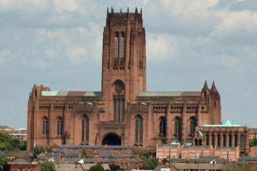 a large building with a clock tower in a city at The BALTIC LODGE NO2 3 BEDROOM AT CAINS BREWERY in Liverpool