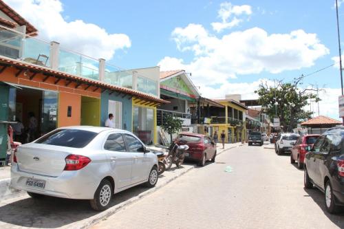 a white car parked on the side of a street at Pousada Vilas Boas in Barreirinhas