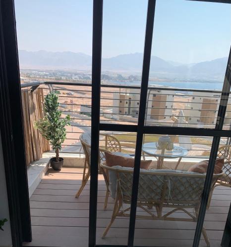 a view of a balcony with a table and chairs at Sea view penthouse Private rooftop jacuzzi in Eilat