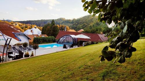 a house with a yard with a swimming pool at UniqHotel Česky Šternberk in Český Šternberk