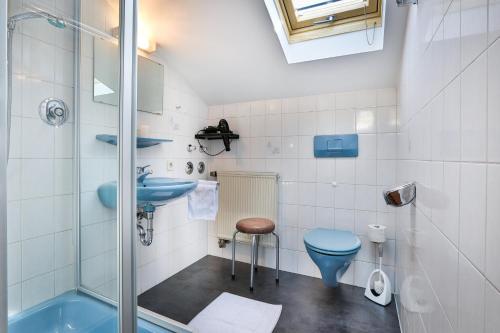 bagno con servizi igienici blu e lavandino di Haus am Reschenberg Ferienwohnungen a Ramsau