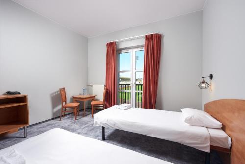 Łóżko lub łóżka w pokoju w obiekcie Hotel Anton by DNS